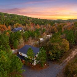 Aerial view of the roof and gravel drive among pines