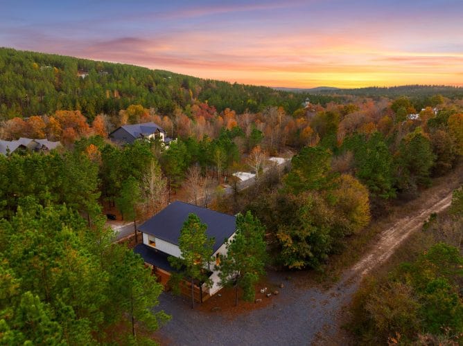 Aerial view of the roof and gravel drive among pines