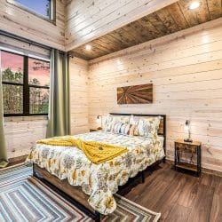 Second queen bedroom with a floral comforter and green curtains