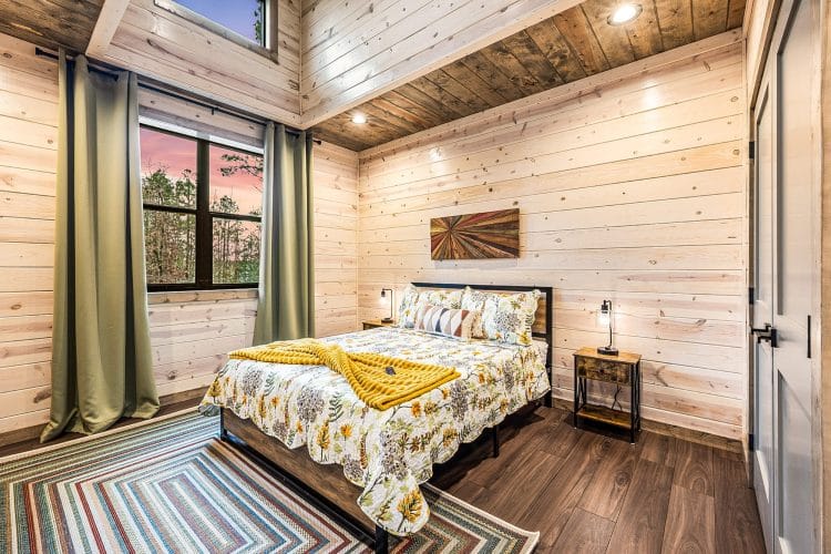 Second queen bedroom with a floral comforter and green curtains