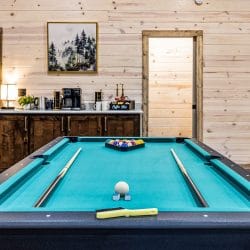 Teal pool table with the coffee bar behind it
