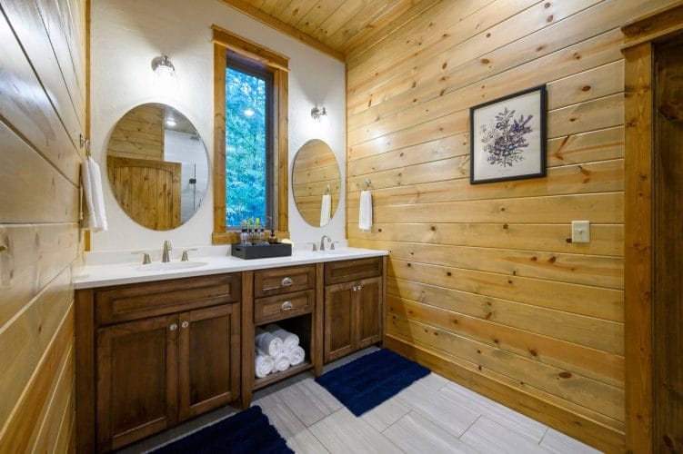 Double vanity with two round mirrors and a white counter