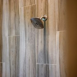 Shower with wood-look tile and a rain-style showerhead