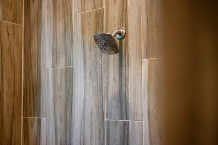Shower with wood-look tile and a rain-style showerhead