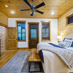 Bed and bench with a door to the outside in the back wall