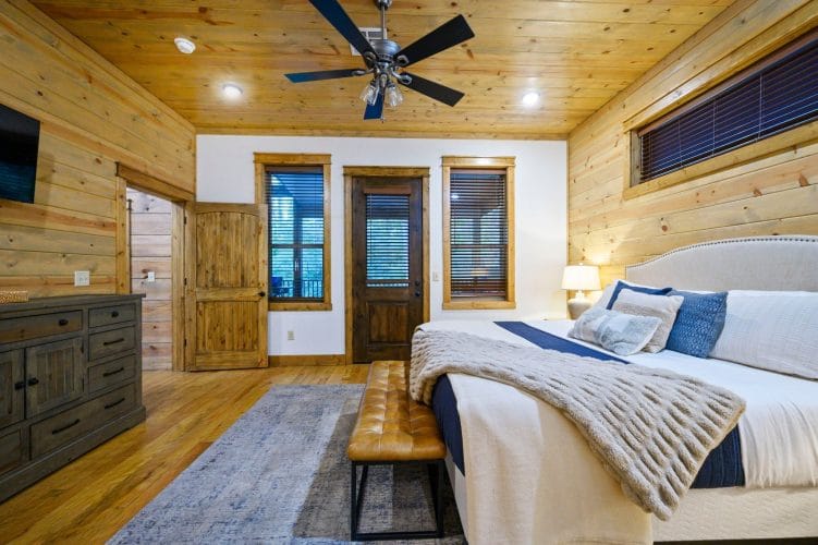 Bed and bench with a door to the outside in the back wall