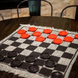 Checkers mat laid out on a round game table