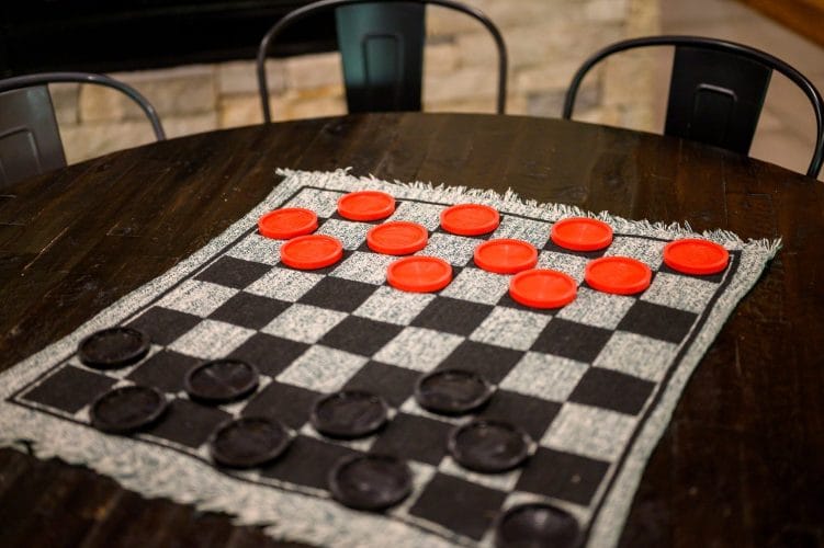 Checkers mat laid out on a round game table