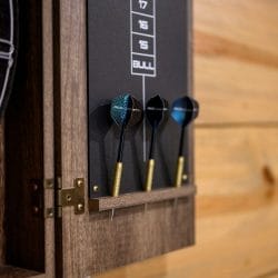 Dart set hanging on the dartboard cabinet