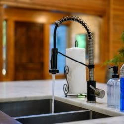 Pull-down kitchen faucet over a stainless sink