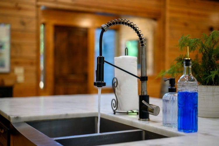 Pull-down kitchen faucet over a stainless sink