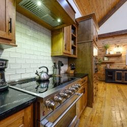 Range with a tile backsplash, drip coffee maker and tea kettle