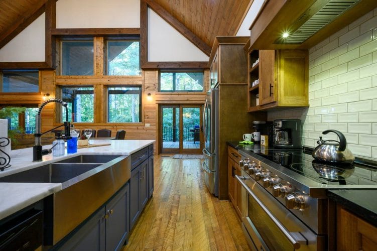 Kitchen sink and range with glass doors to the deck at the far end