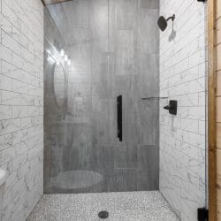 Walk-in shower with gray and white tile