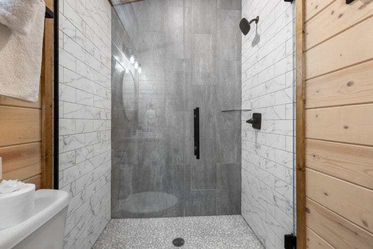 Walk-in shower with gray and white tile