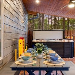 Covered deck with the hot tub behind a long table