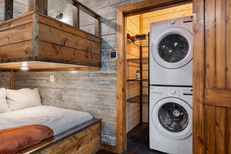 Stacked washer and dryer beside the bunk nook