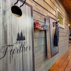 Wooden wall sign on the deck with the cabin name