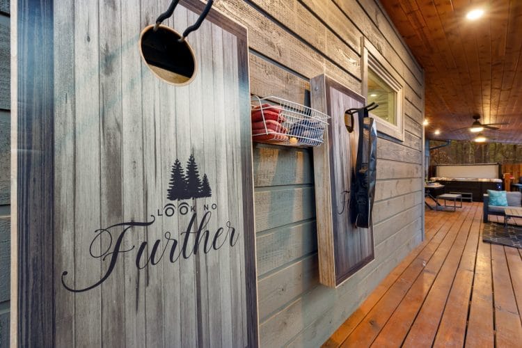 Wooden wall sign on the deck with the cabin name
