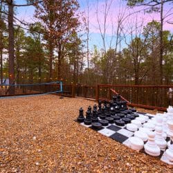 Giant chess set on the gravel under string lights