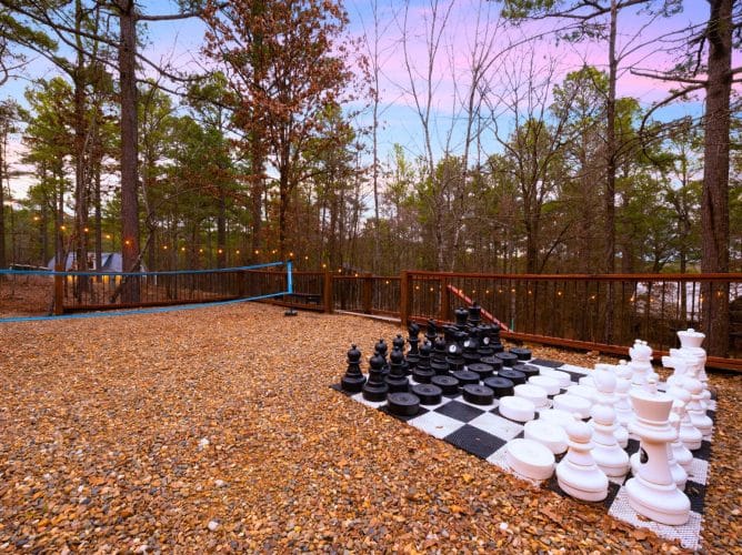 Giant chess set on the gravel under string lights