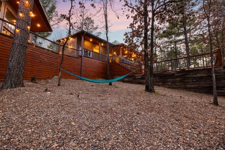 Hammock strung beneath the deck beside the retaining wall