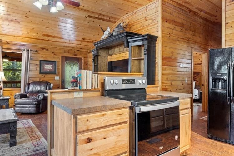 Stainless stove set in a wood-topped counter between the kitchen and the living room