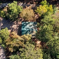 Aerial view straight down on the green roof, gravel drive and tree cover