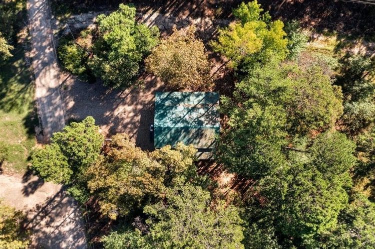 Aerial view straight down on the green roof, gravel drive and tree cover