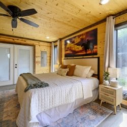 King bed with French doors and framed horse art