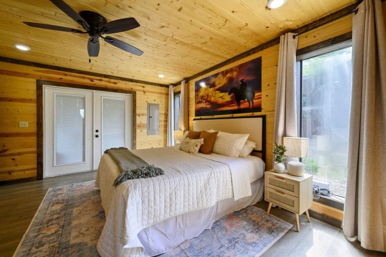 King bed with French doors and framed horse art