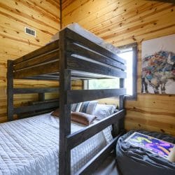 Bunk bed with a bison art print and a beanbag with a game tablet