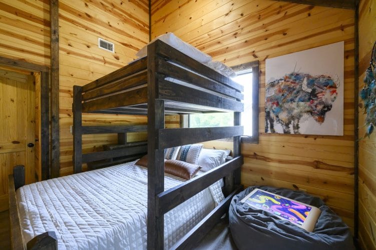 Bunk bed with a bison art print and a beanbag with a game tablet