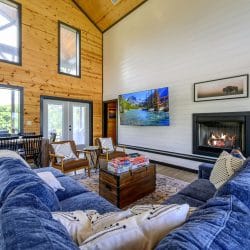 Blue sectional facing a gas fireplace and a wall TV