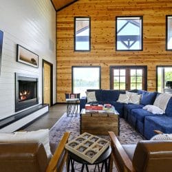 Sectional and leather chairs facing the fireplace, with the TV at left