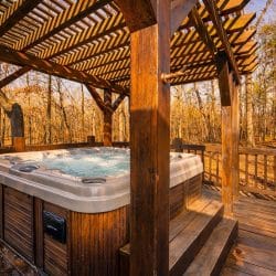 Hot tub on the deck under a wooden pergola