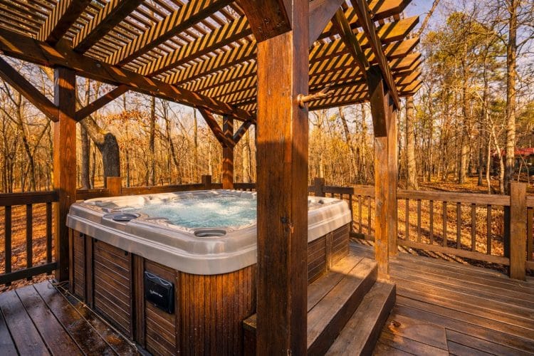 Hot tub on the deck under a wooden pergola