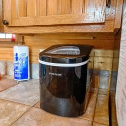 Countertop ice maker beside a roll of paper towels
