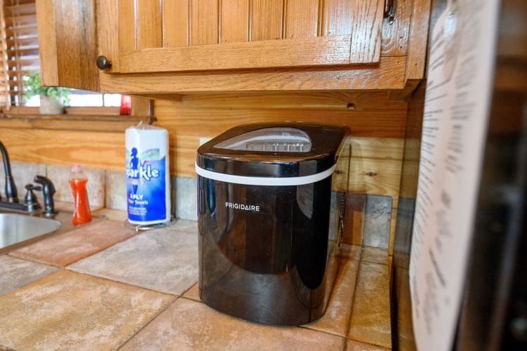 Countertop ice maker beside a roll of paper towels
