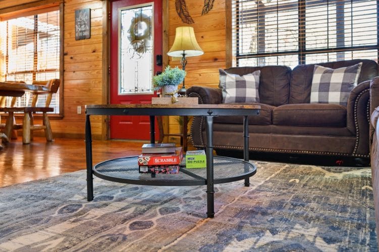 Sofa and a glass coffee table with board games beside the red front door