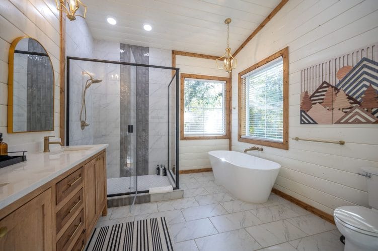 Bathroom with a freestanding tub, a glass walk-in shower and a wood vanity