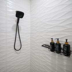Shower with wavy white tile and black fixtures