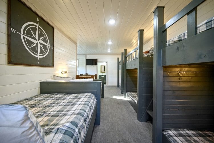 Bunk loft seen from one end, with a plaid daybed in front