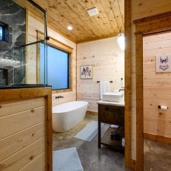 Soaking tub and glass shower in a bathroom with a double vanity