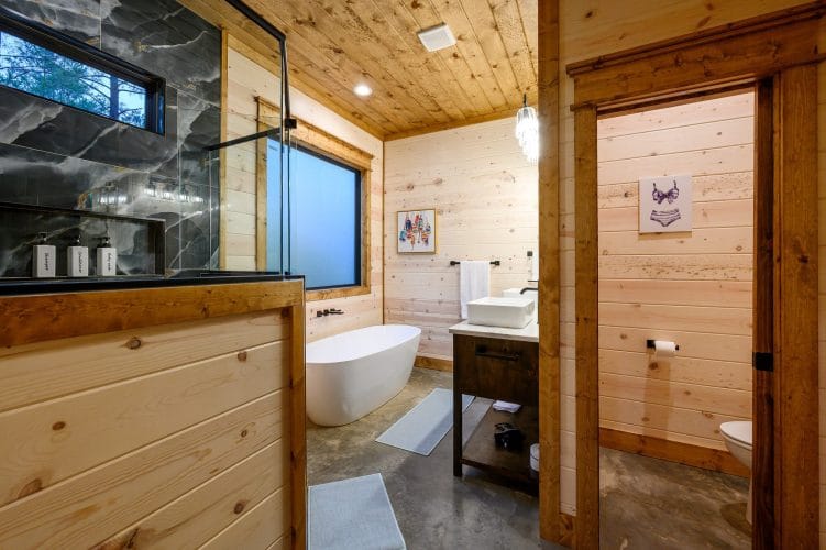 Soaking tub and glass shower in a bathroom with a double vanity