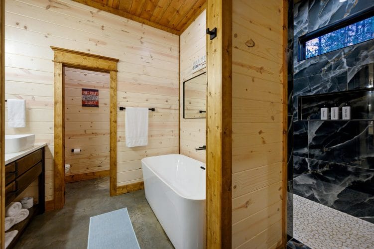 Freestanding tub beside a tile shower