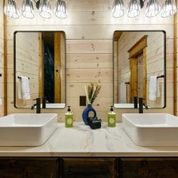 Double vanity with two vessel sinks and black-framed mirrors