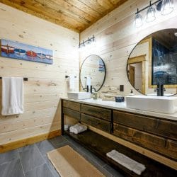 Vanity with two sinks and a round mirror
