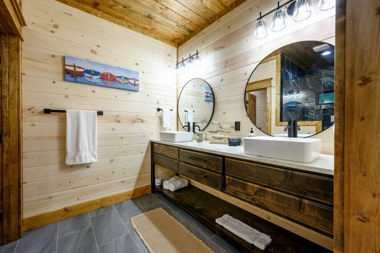 Vanity with two sinks and a round mirror