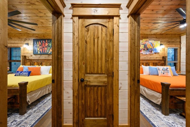 Hallway door between two bedrooms, one with yellow and one with orange bedding